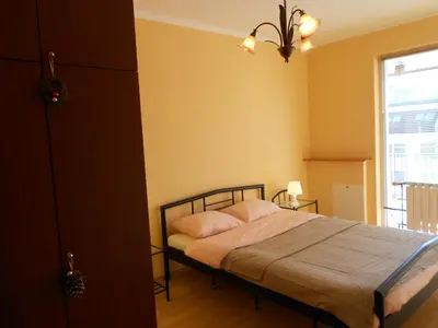 a bedroom with a bed and a window at Апартамент Мур in Sofia