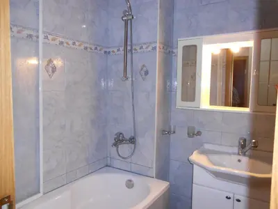 a bathroom with a bath tub and a sink at Апартамент Мур in Sofia