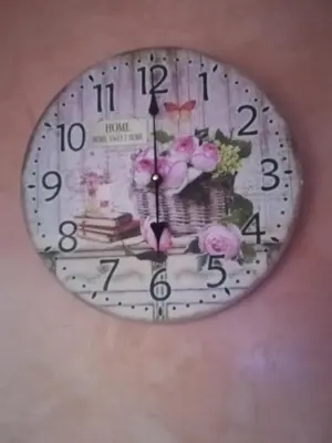 a clock with flowers on it hanging on a wall at Апартамент Мур in Sofia