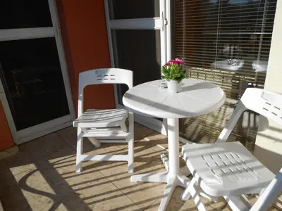 a white table and two chairs and a table and chairs at Апартамент Мур in Sofia