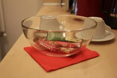 a glass bowl on a table with a red napkin at Apartment 132 in Sofia