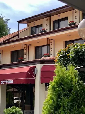 a building with a red awning in front of it at Hotel Ostrova in Plovdiv