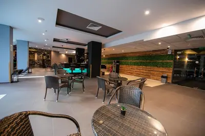 a restaurant with tables and chairs and a bar at Iceberg Apartment 50 in Borovets