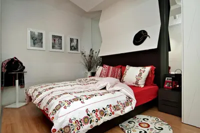 a bedroom with a bed and a red couch at Iceberg Apartment 50 in Borovets