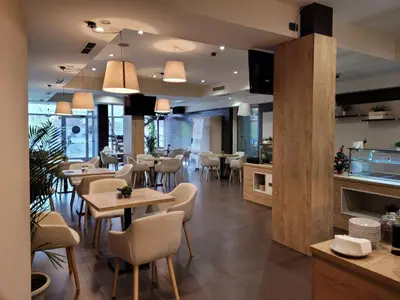 a restaurant with tables and chairs in a room at Sofia Palace Hotel by HMG in Sofia