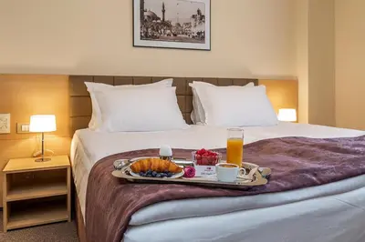 a tray of food on a bed in a hotel room at Sofia Palace Hotel by HMG in Sofia