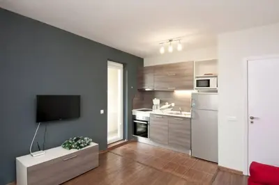 a living room with a kitchen with a tv at Sofia Top Lux Apartment in Sofia
