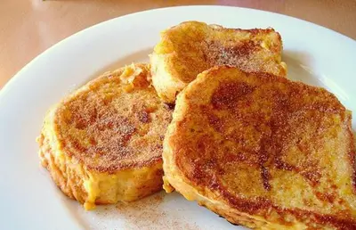 two pancakes on a white plate on a table at Snow Heaven Hotel in Bankya
