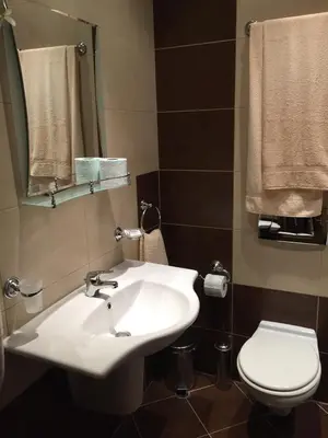 a bathroom with a white sink and a toilet at GM Royal Plaza in Borovets