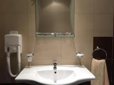 a white sink in a bathroom with a mirror at GM Royal Plaza in Borovets
