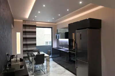 a kitchen with a stainless steel refrigerator and a table at Silver Springs in Sofia