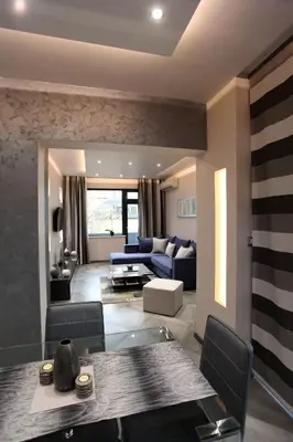a living room with a table and a blue couch at Silver Springs in Sofia