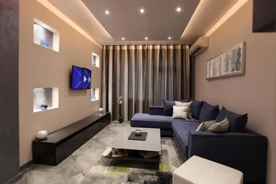 a living room with a blue couch and a table at Silver Springs in Sofia