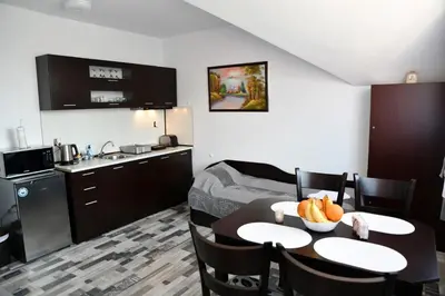 a room with a kitchen and a table with fruit on it at Ski Apartment Boyika Iglika 2 in Borovets