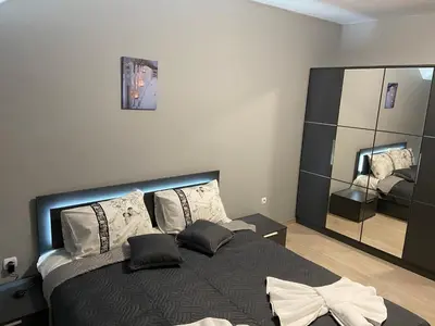 a bedroom with a bed with pillows and a mirror at Ski Apartment Boyika Iglika 2 in Borovets