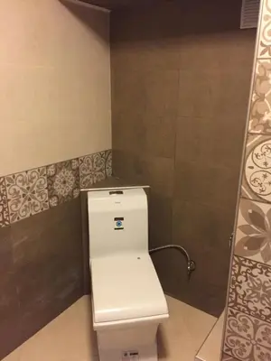 a bathroom with a white toilet in a room at City Garden Studio in Plovdiv