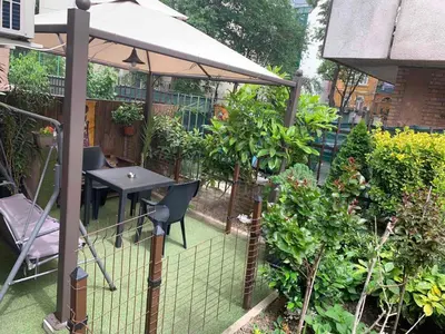 a garden with a table and an umbrella at City Garden Studio in Plovdiv