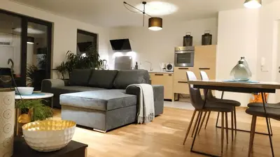 a living room with a couch and a table at Baratero Club Apartments Private Parking EV points in Sofia