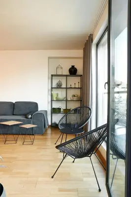 a living room with two chairs and a couch at Baratero Club Apartments Private Parking EV points in Sofia