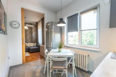 a kitchen and dining room with a table and chairs at Rentapart Step in Sofia