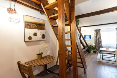 a room with a ladder and a bench and a table at Rentapart Step in Sofia