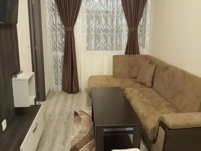 a living room with a couch and a table at Ayberk Apart Sandanski in Sandanski