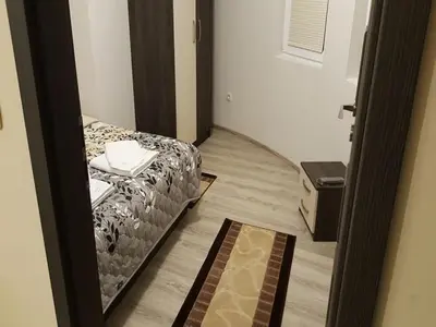 a small room with a bed and a rug at Ayberk Apart Sandanski in Sandanski