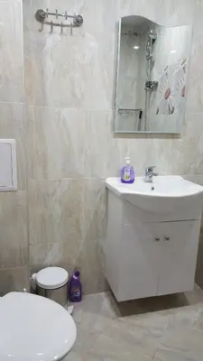 a bathroom with a white sink and a mirror at Ayberk Apart Sandanski in Sandanski