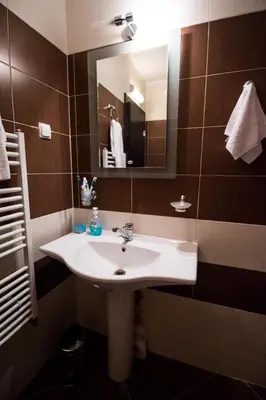 a bathroom with a sink and a mirror at Iglika 2 Ski Apartment in Borovets