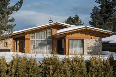 a house with snow on the roof at Villa Nataly at Golf Resort in Bansko