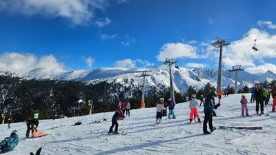 a group of people on a snow covered ski slope at Ramada 2 Boutique Apartment near Ski Road in Bansko