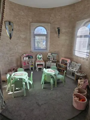 a room with tables and chairs in a play room at Royal Valentina Castle in Ognyanovo