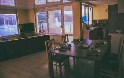 a dining room with a table and chairs in a room at Lakeview-Estate ApartHotel in Staro Myasto