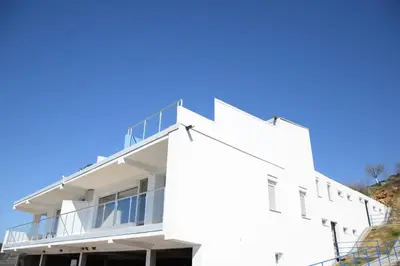 a white building with a balcony on the side of it at Lakeview-Estate ApartHotel in Staro Myasto