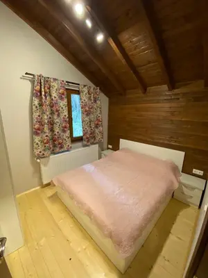 a bedroom with a pink bed in a room at Persey Villa Borovets in Borovets