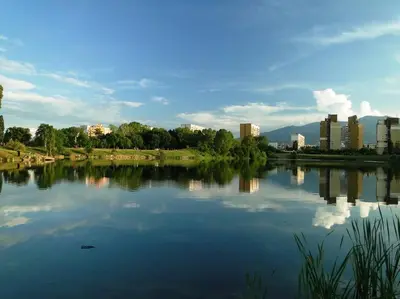 a view of a lake with a city in the background at Airport Apartment in Sofia