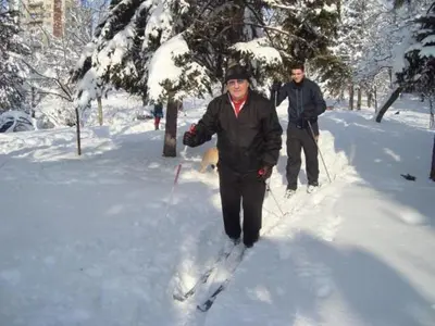 two men are cross country skiing in the snow at Бунгала Говедарци in Govedartsi