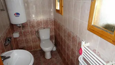 a small bathroom with a toilet and a sink at Бунгала Говедарци in Govedartsi