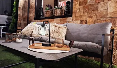 a coffee table in front of a couch at Kadiyata Guest House in Bansko
