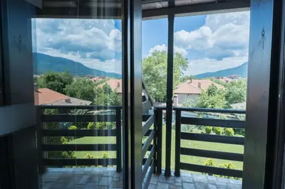 a view from the window of a balcony at Kadiyata Guest House in Bansko