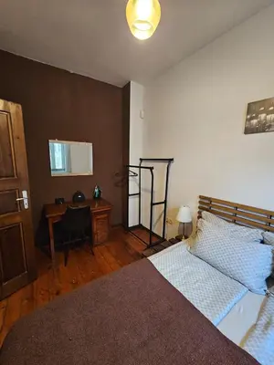 a bedroom with a bed and a desk and a table at Hot Spot Apartments in Sofia