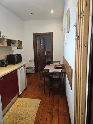 a kitchen and dining room with a table and chairs at Hot Spot Apartments in Sofia