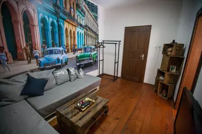 a living room with a couch and a painting of cars at Hot Spot Apartments in Sofia