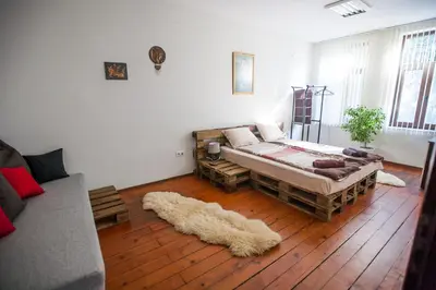 a living room with a bed and a couch at Hot Spot Apartments in Sofia