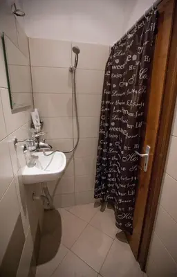 a bathroom with a shower curtain and a sink at Hot Spot Apartments in Sofia