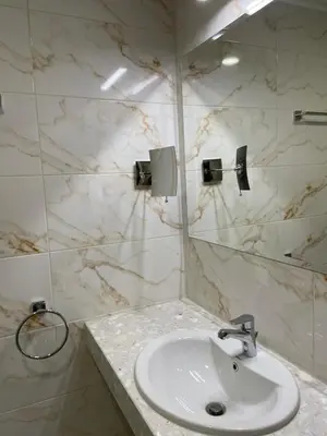 a bathroom with a sink and a mirror at Balneo & SPA Hotel Aura in Velingrad