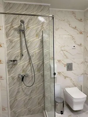 a shower stall in a bathroom with a toilet at Balneo & SPA Hotel Aura in Velingrad