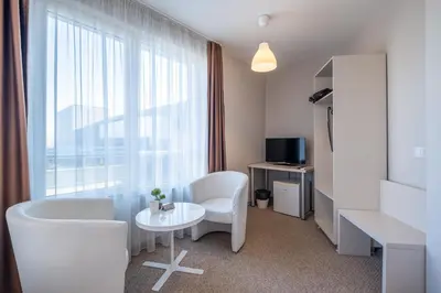 a room with a table and chairs and a window at Blue Label Apart House in Sofia