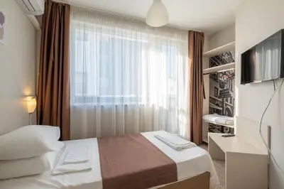 a hotel room with a bed and a window at Blue Label Apart House in Sofia