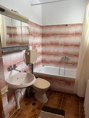 a bathroom with a toilet and a sink and a tub at Mama Emiliya Guest House in Beli Iskar
